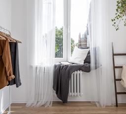 Fenster mit Gardinen und Kissen
