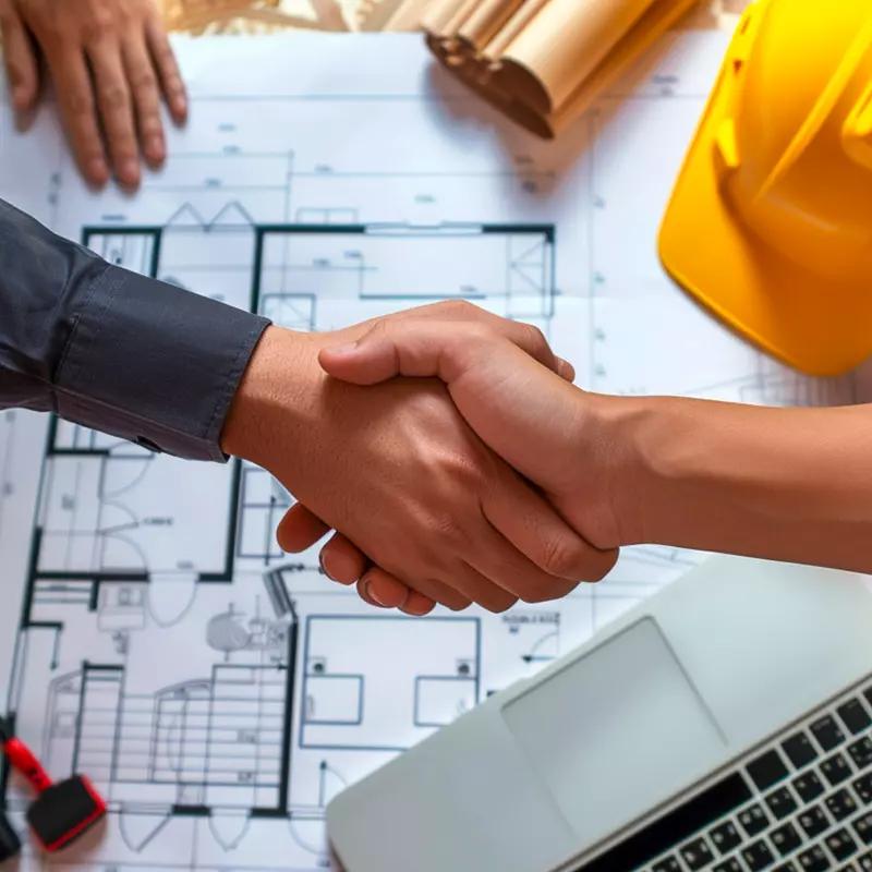Handshake over construction plans